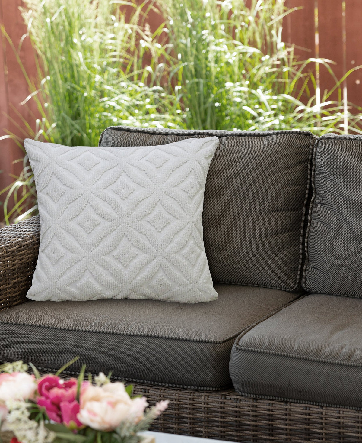 Vibhsa white ogee throw pillow 18x18 with textured diamond pattern on wicker outdoor sofa on Tampa Home & Garden Store