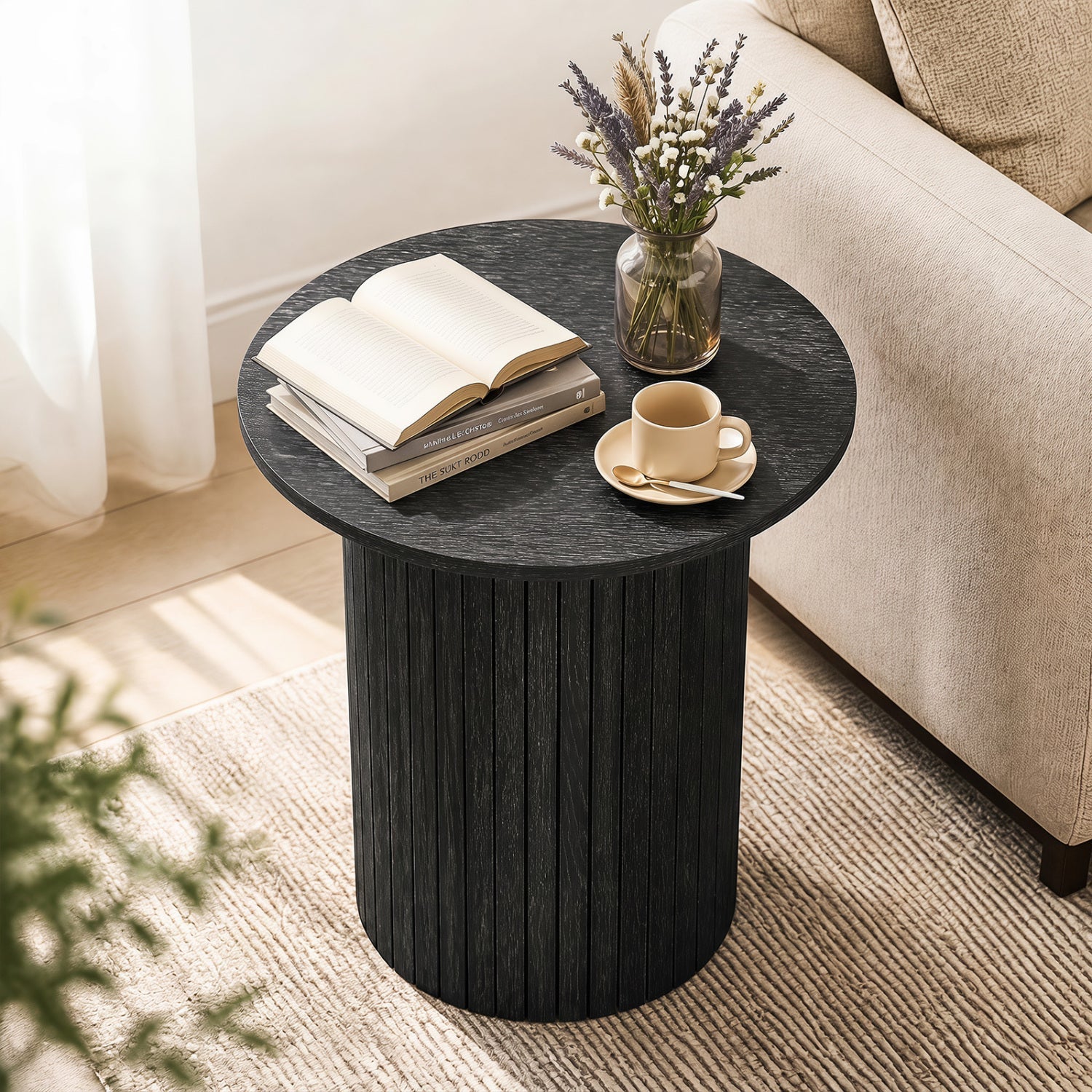 18-inch round fluted side table with pedestal drum base in black wood grain; books, vase, teacup on Tampa Home & Garden Store