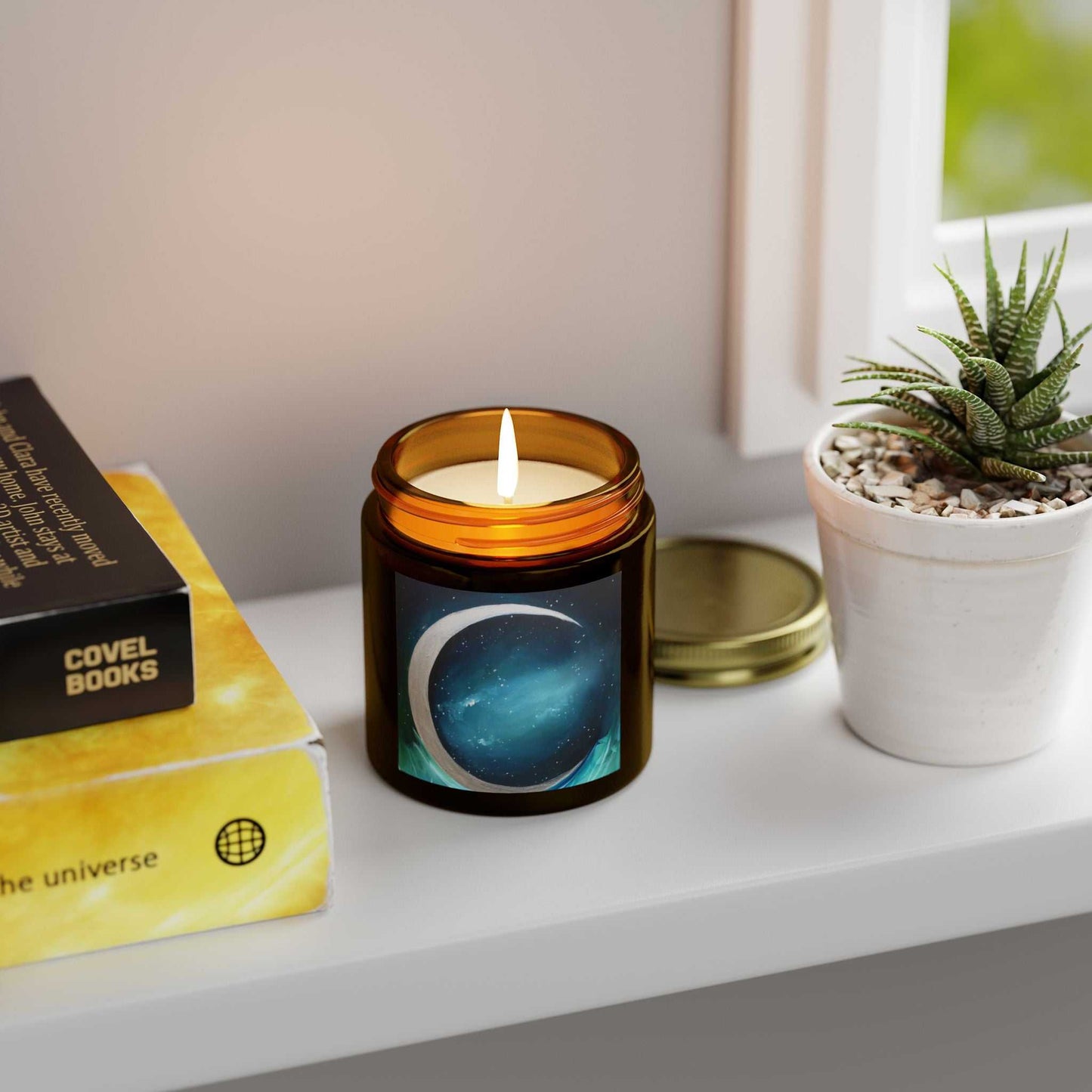 Scented Mai Autumn Coconut Apricot Wax candle in amber jar with flame beside a succulent plant on Tampa Home & Garden Store