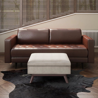 Owen upholstered rectangular storage ottoman in beige fabric by Unique Piece Furniture, paired with a brown leather sofa on Tampa Home & Garden Store