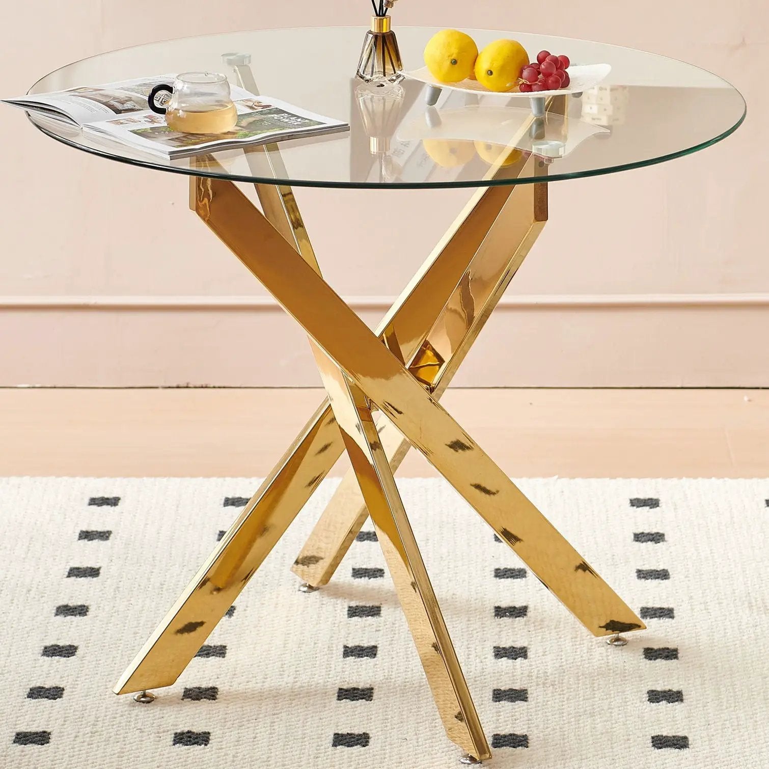 Dining table with round tempered glass top and gold cross-metal legs by Unique Piece Furniture on Tampa Home & Garden Store