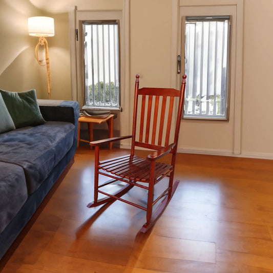 Brown wooden porch rocking chair with slatted seat and back beside a blue sofa on Tampa Home & Garden Store