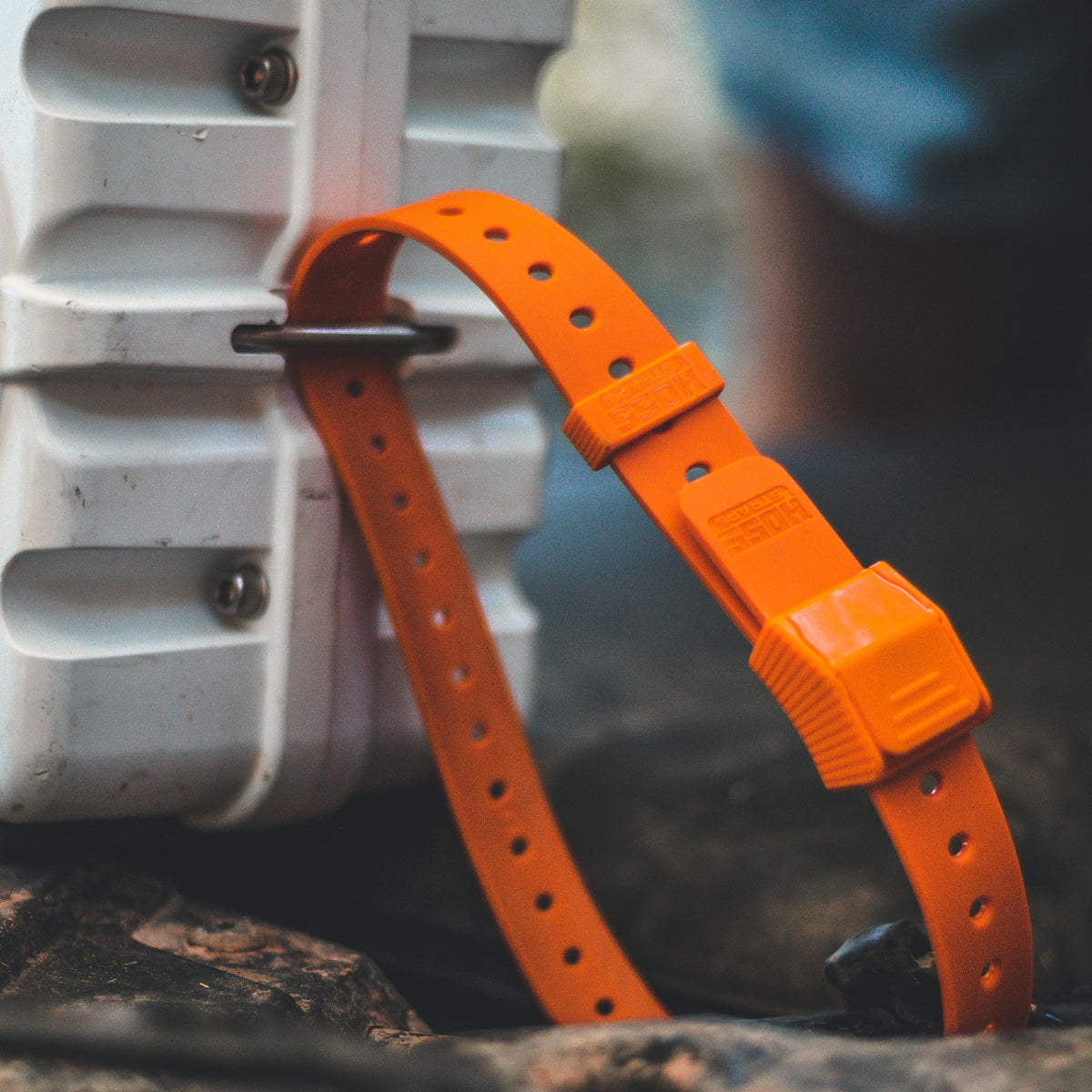 Gear Straps 24-Inch orange strap by Hoss Straps looped around gray gear on Tampa Home & Garden Store