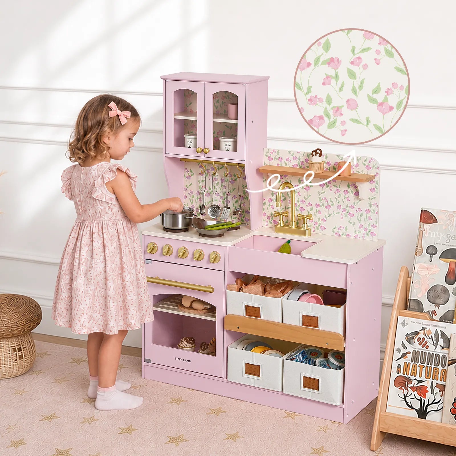 Tiny Land wooden pink play kitchen with storage, stove, and sink; child playing with pot on Tampa Home & Garden Store