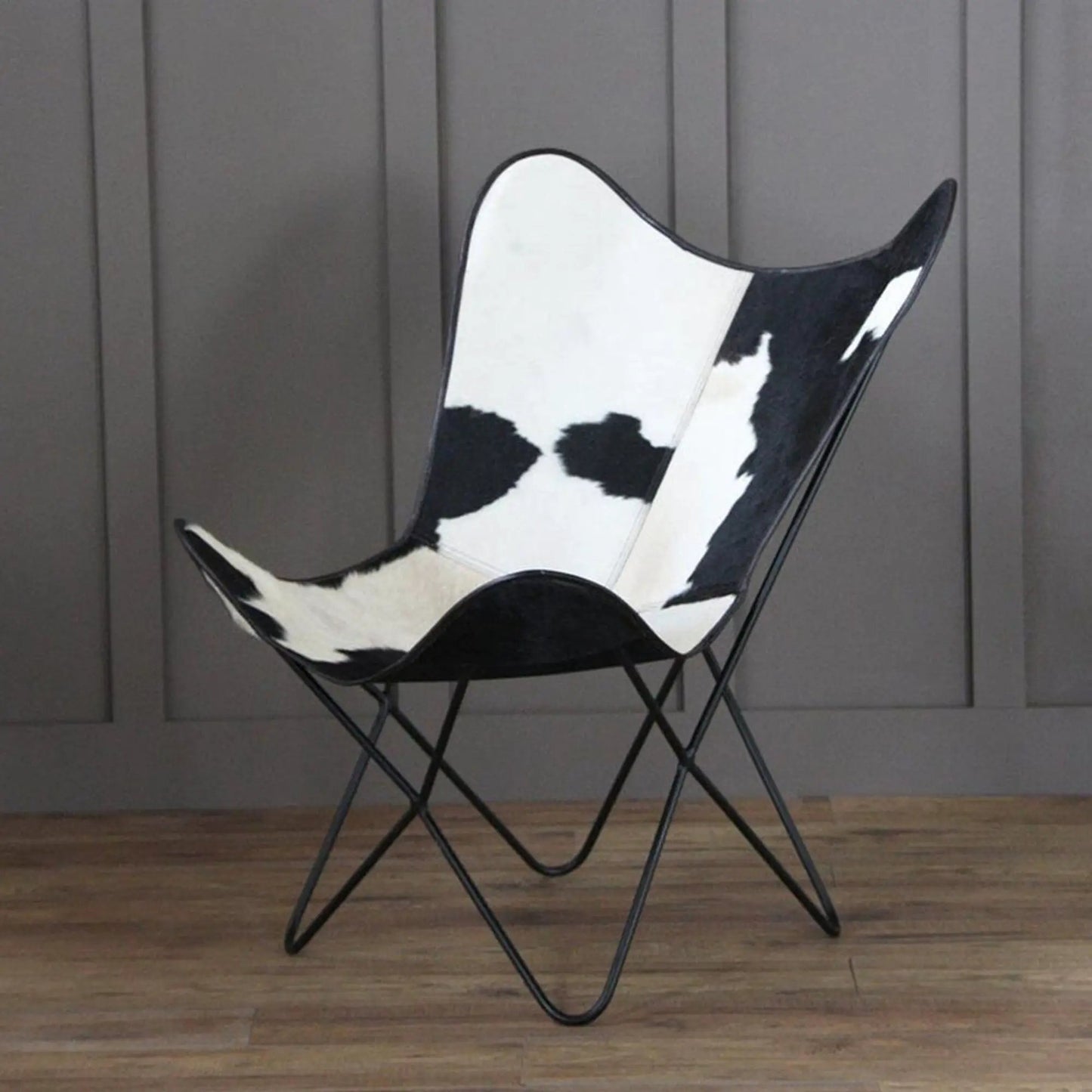 The Holsteins Butterfly Chair with black and white cowhide upholstery on a black metal frame on Tampa Home & Garden Store