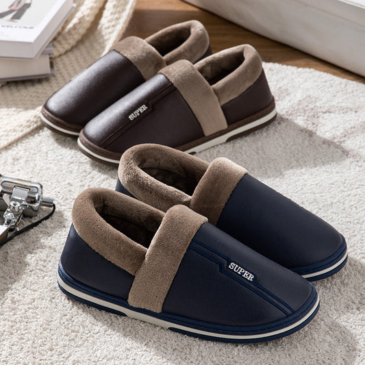 Two pairs of navy blue and brown faux leather indoor slippers with beige plush lining on Tampa Home & Garden Store