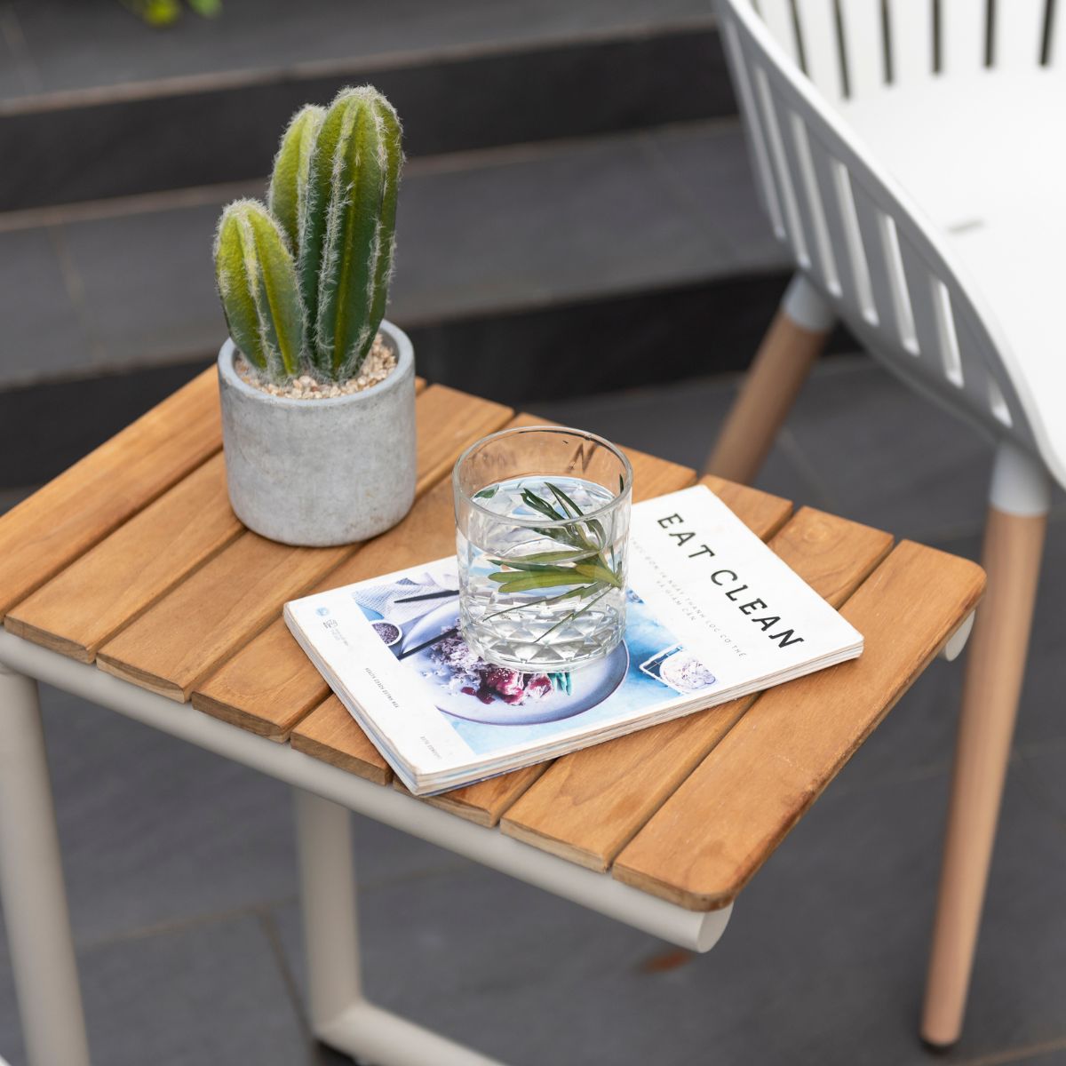 Portals Light C-Shape outdoor side table with wood slats on a patio with a cactus on Tampa Home & Garden Store