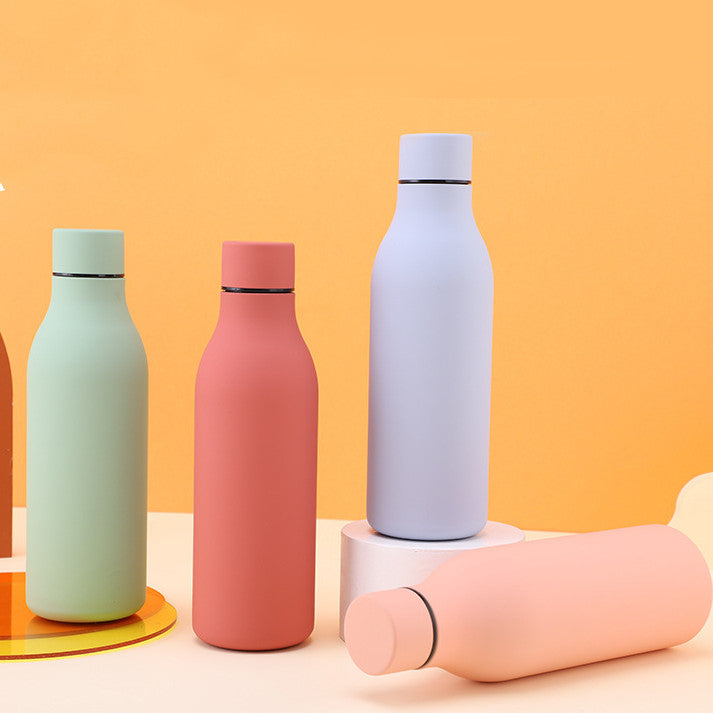 Five pastel stainless steel thermal water bottles with BPA-free caps on orange backdrop on Tampa Home & Garden Store