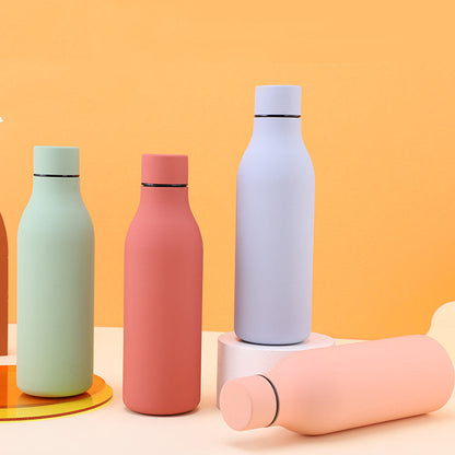 Five pastel stainless steel thermal water bottles with BPA-free caps on orange backdrop on Tampa Home & Garden Store