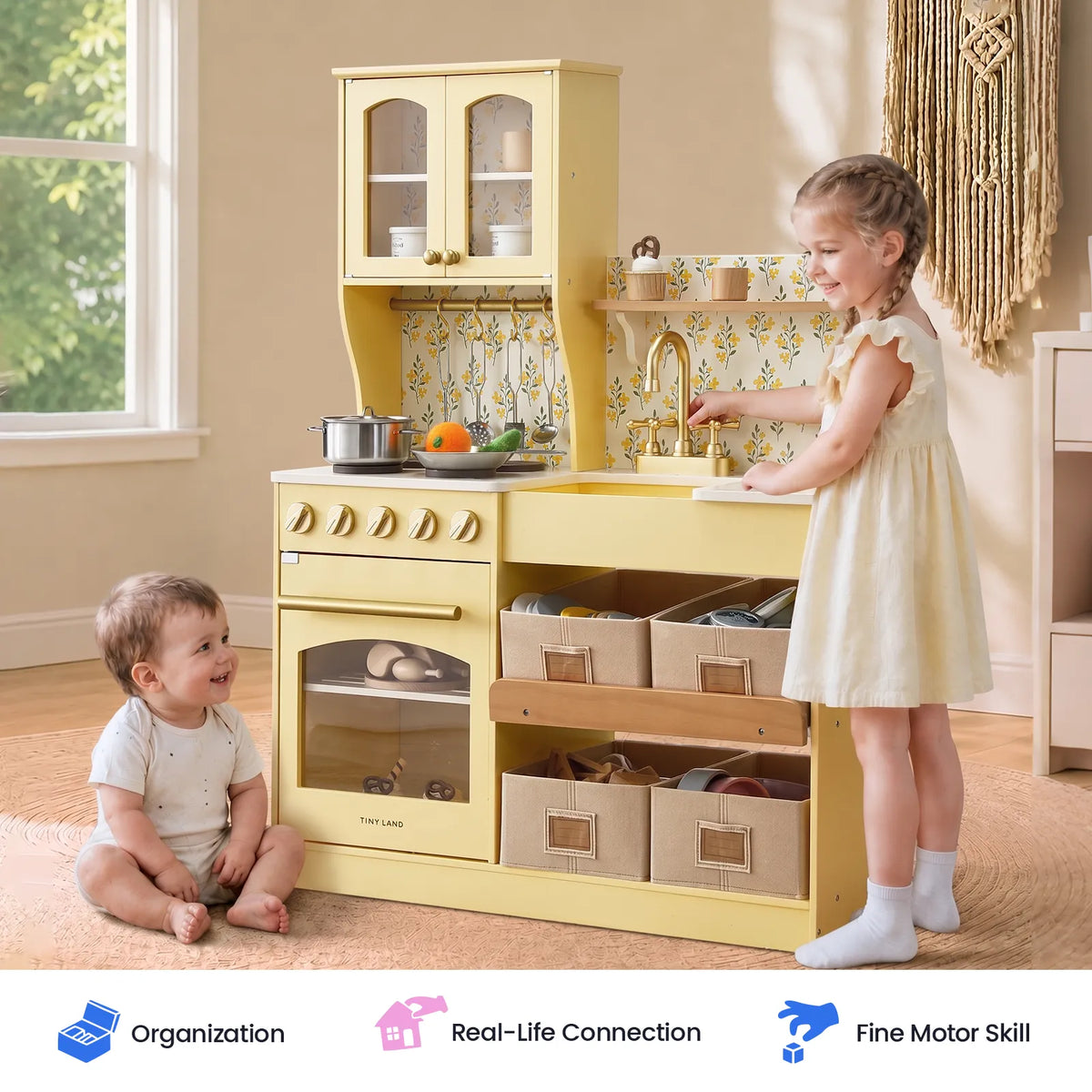 Tiny Land wooden play kitchen with yellow finish, storage drawers and sink; two toddlers playing on Tampa Home & Garden Store