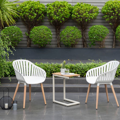 Portals Light C-shape Chair Set: two white outdoor chairs with wooden legs on a gray patio on Tampa Home & Garden Store