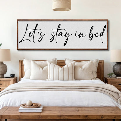 Let's Stay in Bed Sign II canvas wall art with black script on gray panel in wood frame on Tampa Home & Garden Store