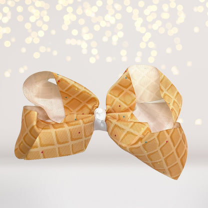 Ice Cream Cone Hair Bow, 6-inch waffle cone ribbon with peach-gold pattern and white center knot on Tampa Home & Garden Store