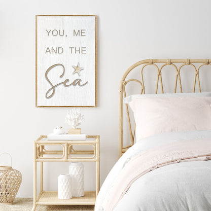 Tailored Canvases You Me and the Sea sign canvas on whitewashed board beside a rattan bed on Tampa Home & Garden Store