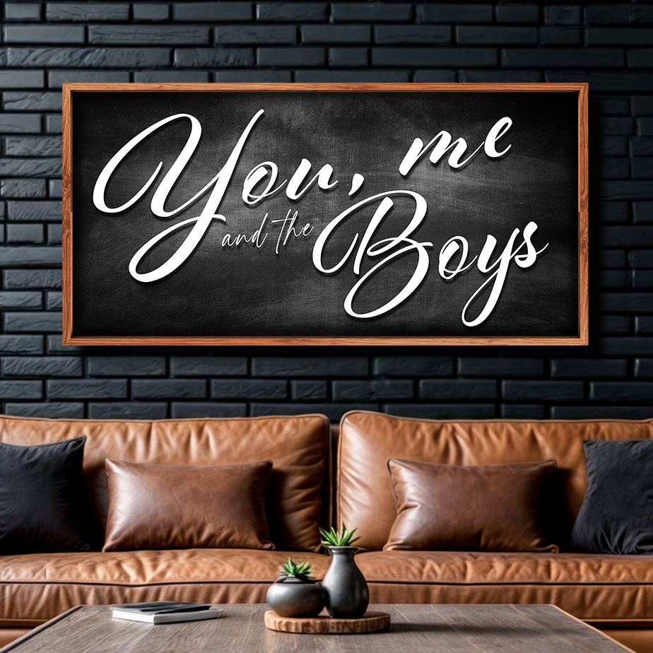 Farmhouse canvas sign You Me and the Boys on black chalkboard in wood frame above sofa on Tampa Home & Garden Store