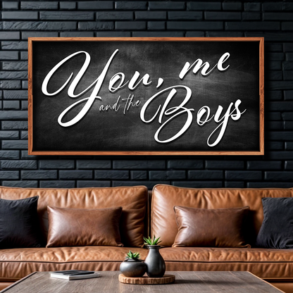 Farmhouse canvas sign You Me and the Boys on black chalkboard in wood frame above sofa on Tampa Home & Garden Store