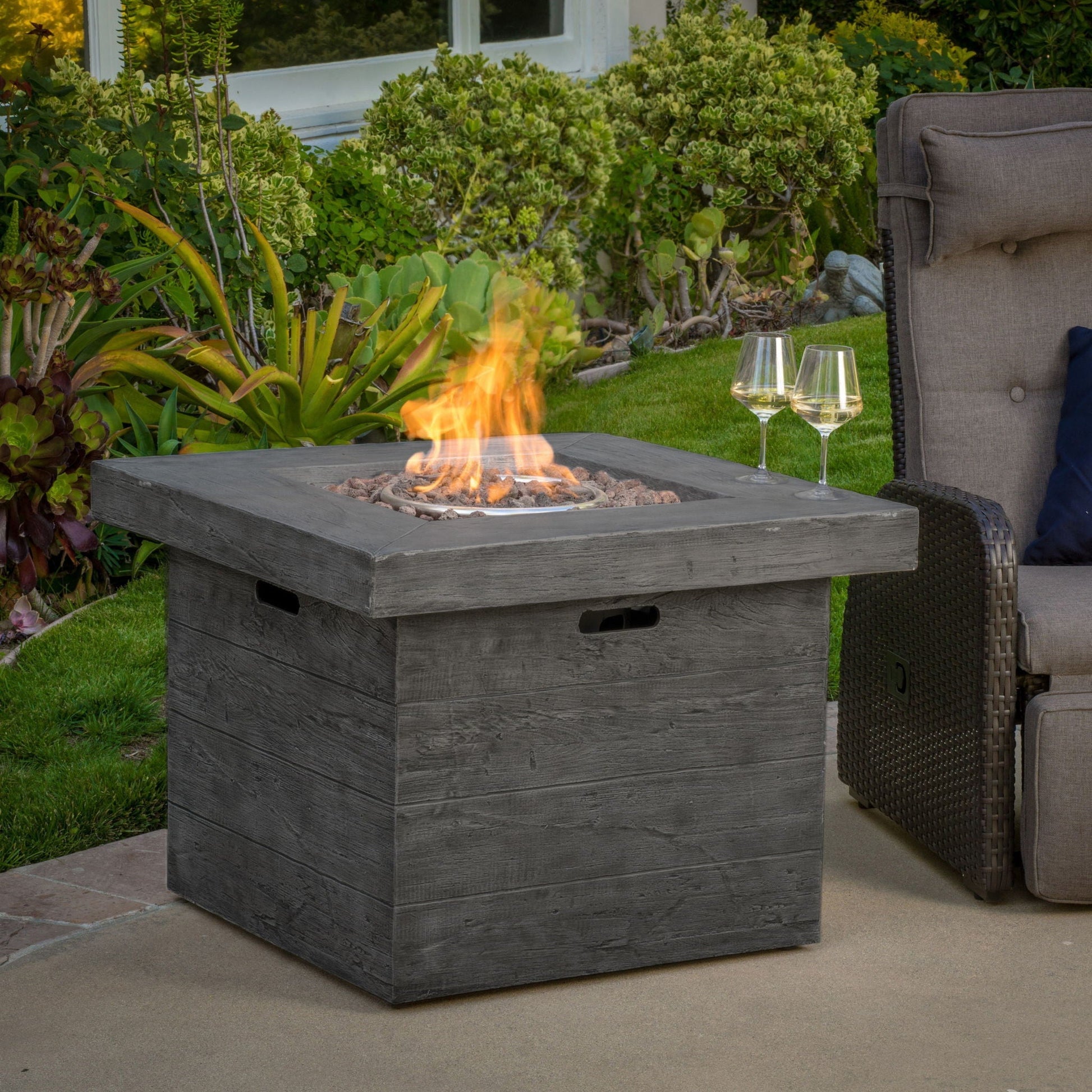 Anchorage Wood Square Fire Pit 40,000 BTU gray gas fire pit on outdoor patio on Tampa Home & Garden Store