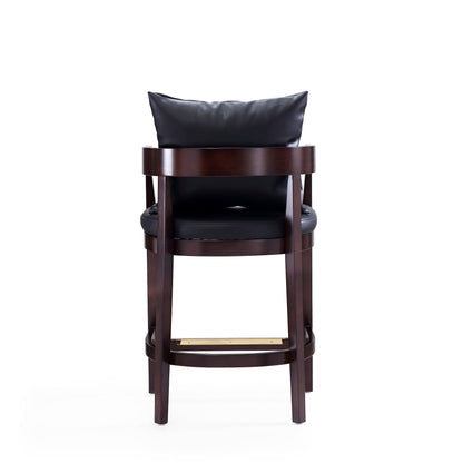 Mid-Century Modern counter stool with black upholstered seat on dark wood frame and gold footrest on Tampa Home & Garden Store
