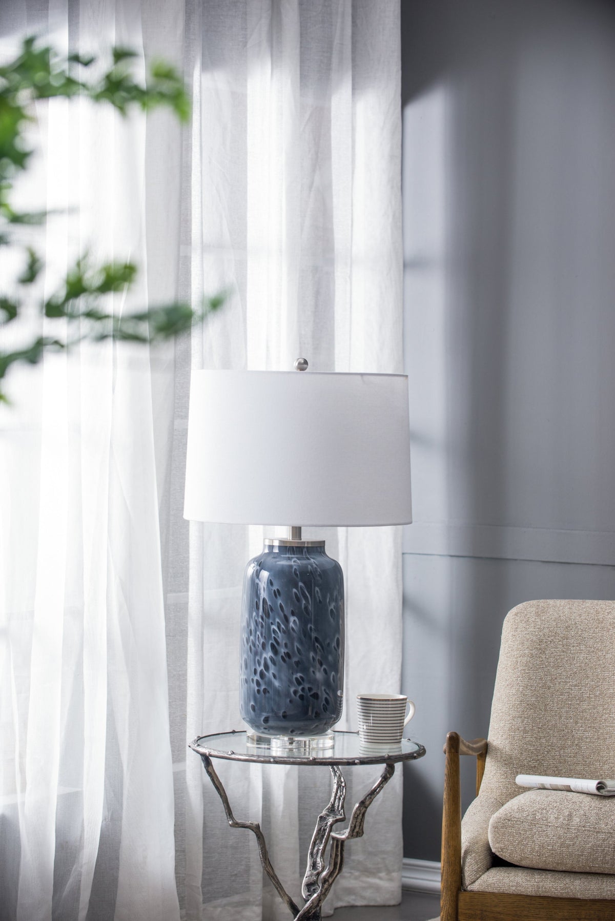 Ellis Glass Table Lamp blue ceramic base with white drum shade on glass-topped table on Tampa Home & Garden Store