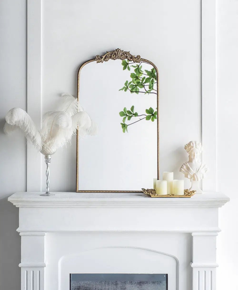 Arch Mirror with baroque gold frame atop white mantel, reflecting greenery and decor on Tampa Home & Garden Store