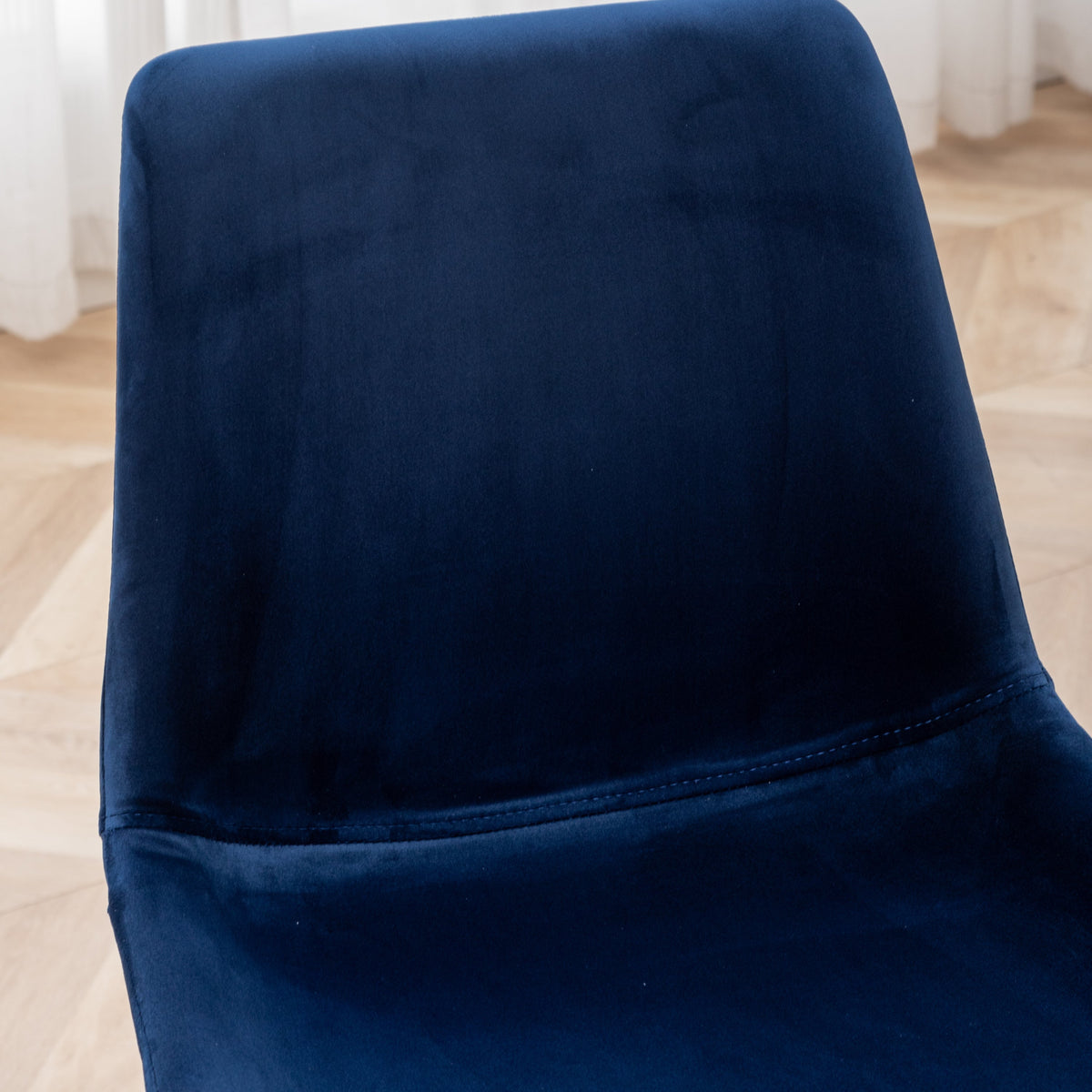 Dining chair back in blue velvet fabric with visible seam stitching on Tampa Home & Garden Store