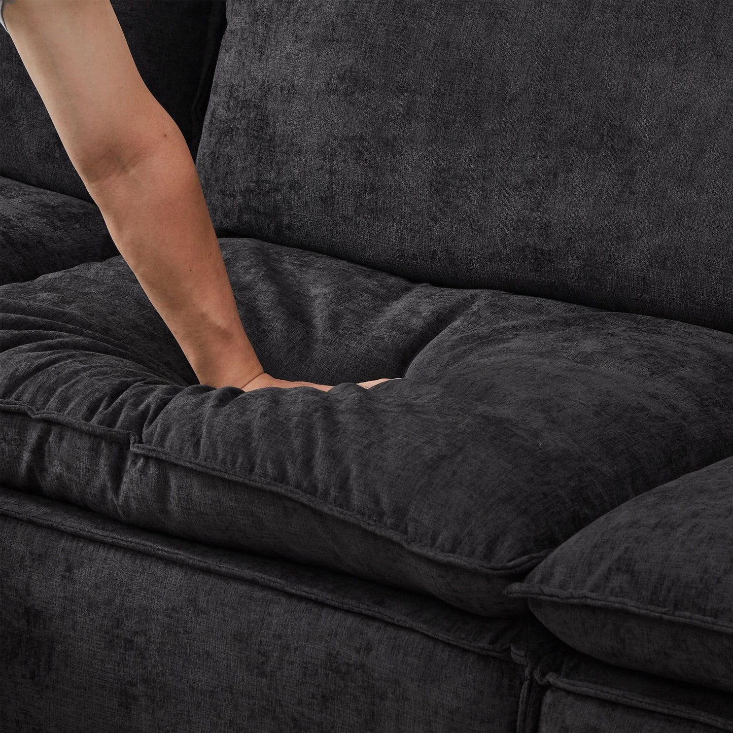 108.5-inch modular sectional sofa in charcoal gray fabric with movable ottoman; arm resting on cushion on Tampa Home & Garden Store