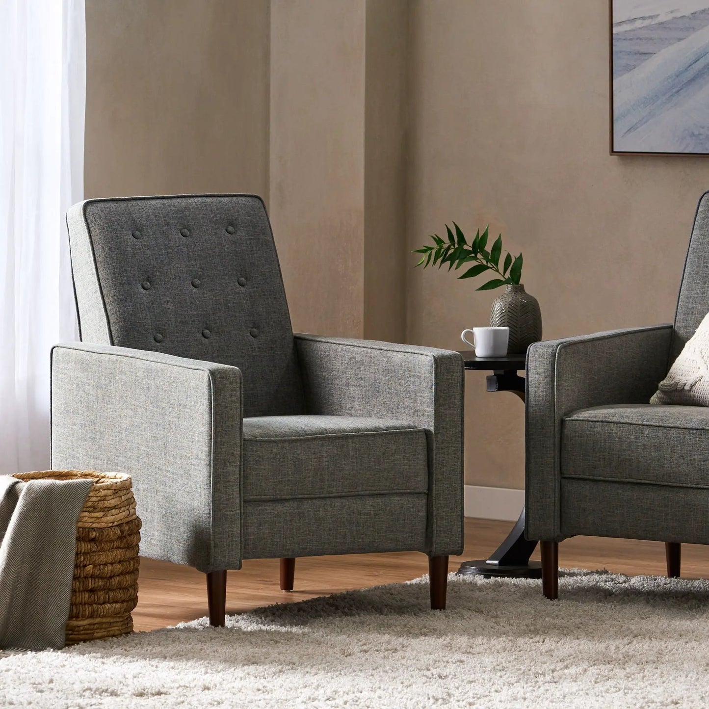 Two gray fabric recliners with button tufting and dark wood legs in a mid-century modern style on Tampa Home & Garden Store