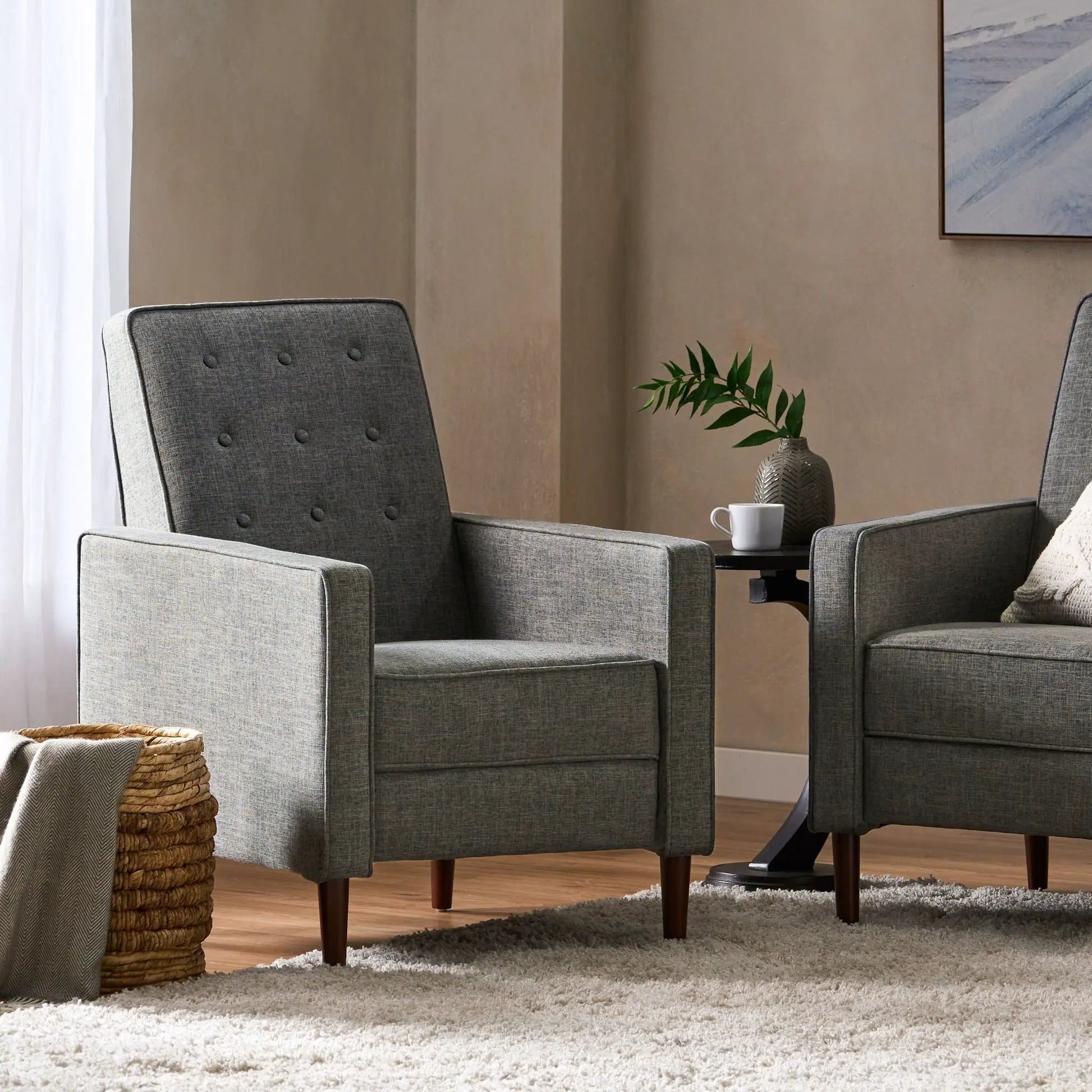 Two gray fabric recliners with button tufting and dark wood legs in a mid-century modern style on Tampa Home & Garden Store