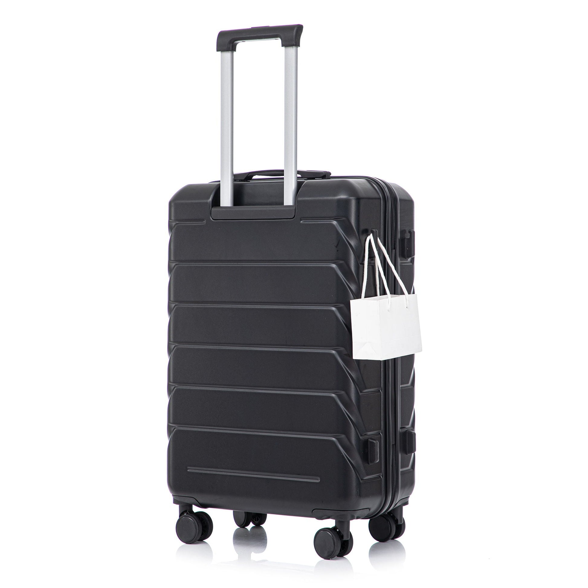 Black hard-shell spinner luggage with silver handle and four wheels, tag attached on Tampa Home & Garden Store