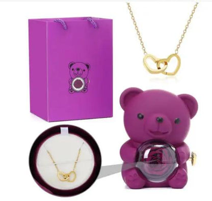 Purple bear-shaped rotating rose jewelry box with gold heart necklace and gift bag on Tampa Home & Garden Store