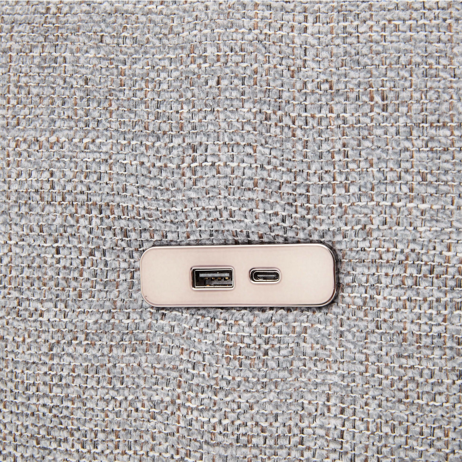 Beige wall outlet with USB ports on gray textured carpet closeup on Tampa Home & Garden Store