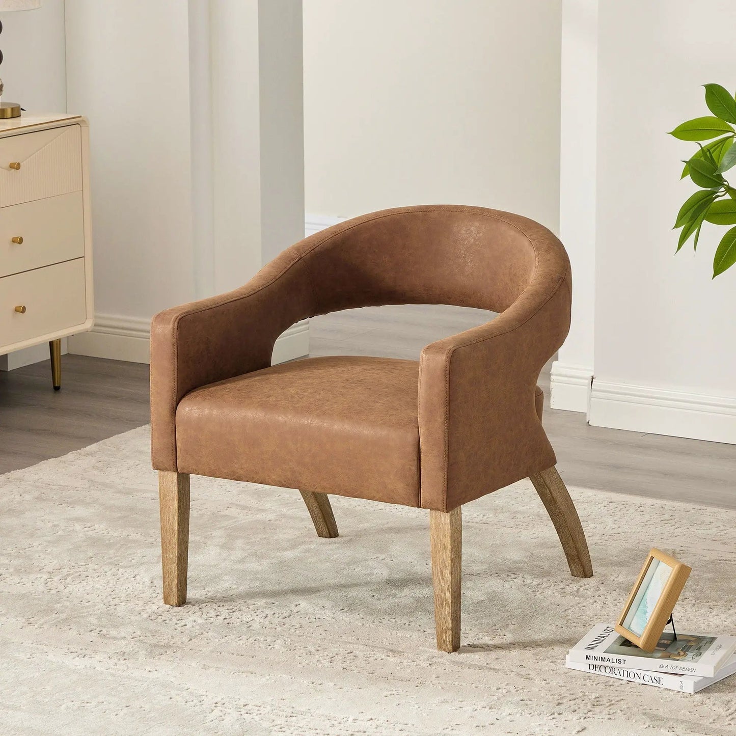 Upholstered open-back armchair in warm brown faux leather with weathered rubberwood legs on Tampa Home & Garden Store