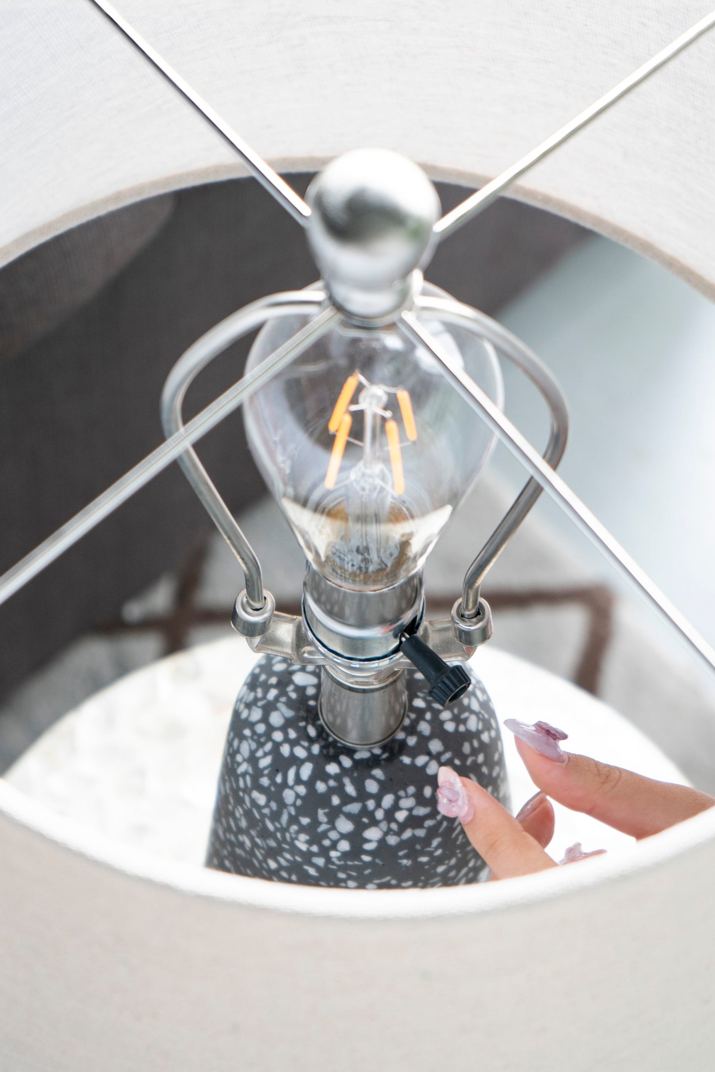 Artisan Multicolor Glass Table Lamp with a speckled gray ceramic base and chrome wireframe on Tampa Home & Garden Store