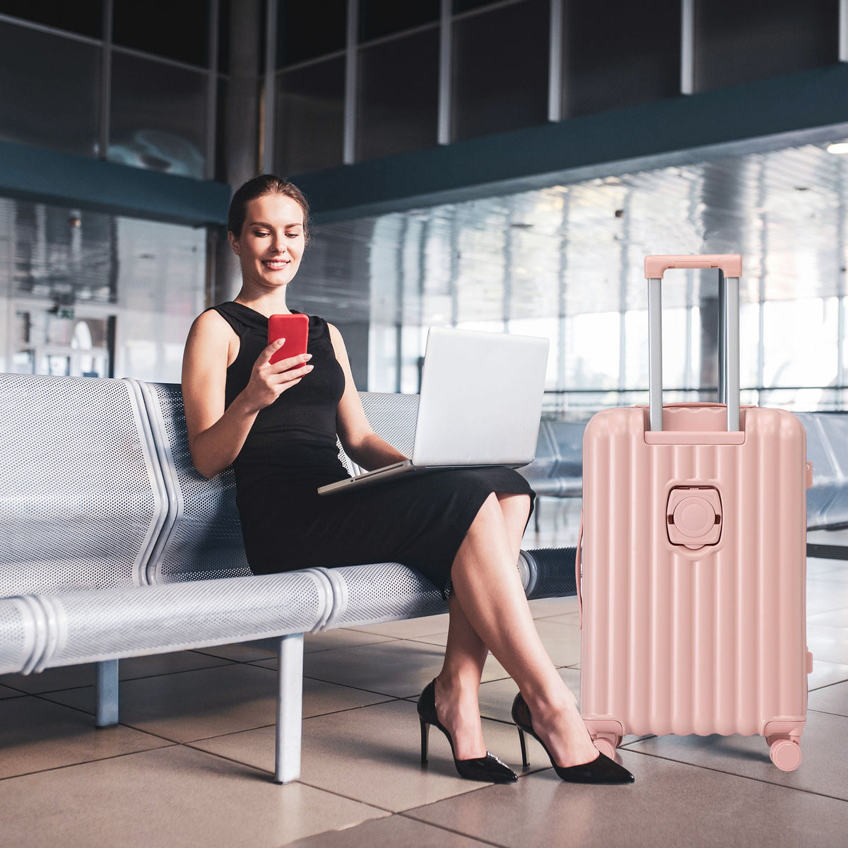 Pink spinner carry-on suitcase by HouseOfZazla with extended handle in airport lounge on Tampa Home & Garden Store