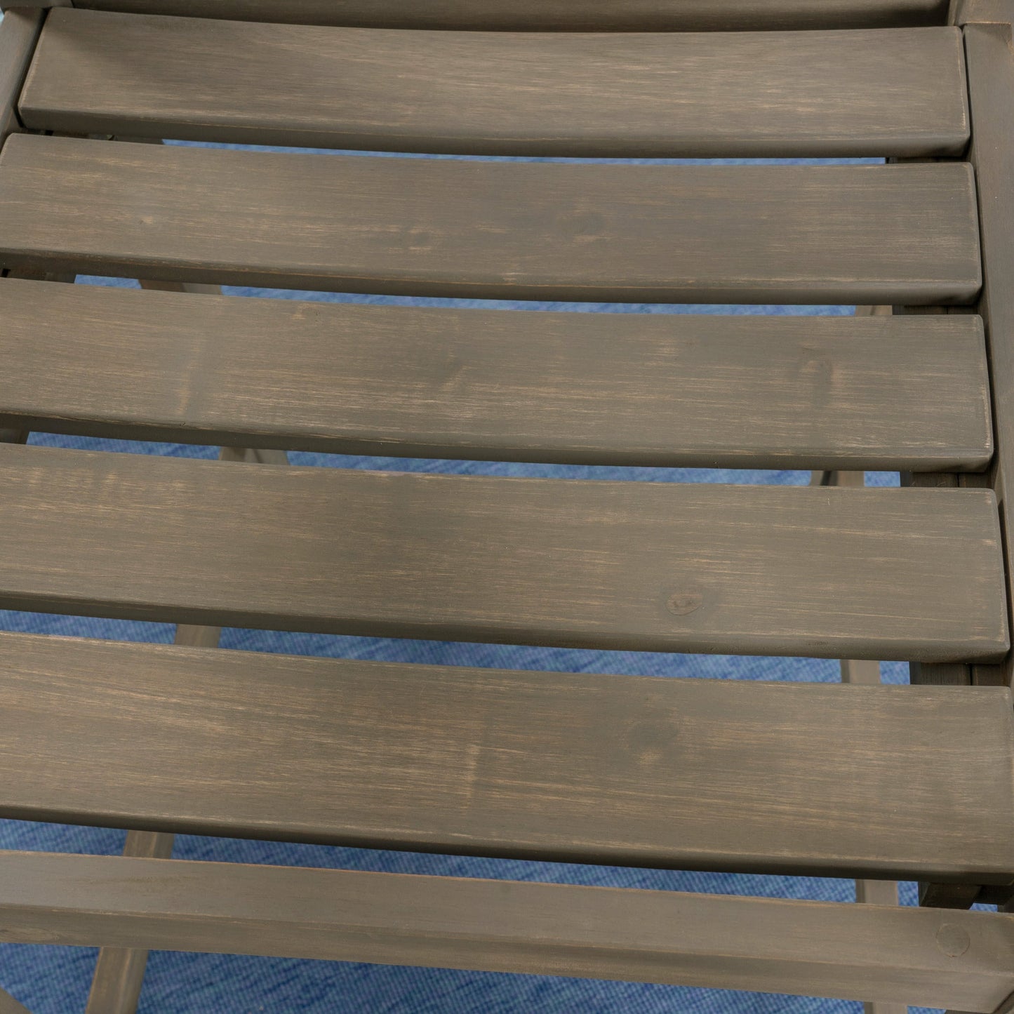 Stamford Barstool brown stained wood slats with blue fabric peeking beneath on Tampa Home & Garden Store
