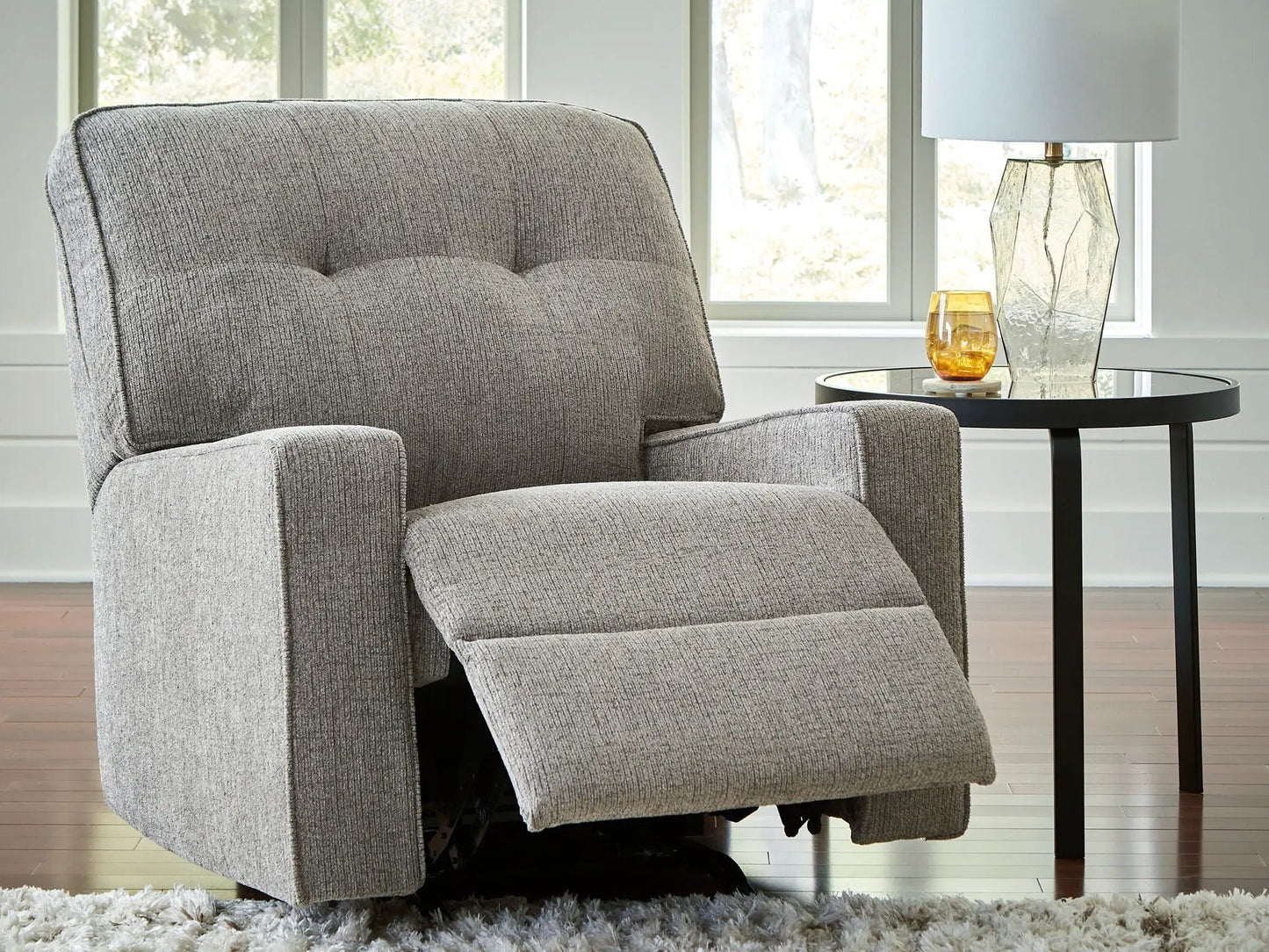 Larimer rocker recliner in gray fabric by Unique Piece Furniture; glass side table, lamp nearby on Tampa Home & Garden Store