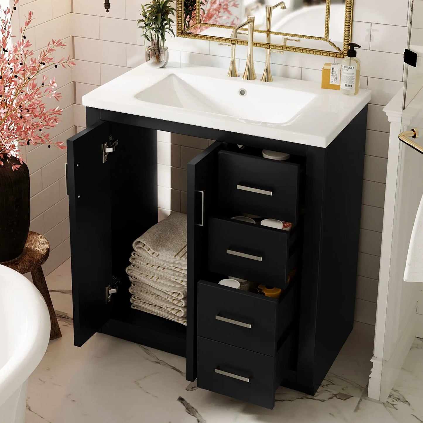 Black freestanding bathroom vanity with white sink, gold faucet, three drawers and open shelf storage on Tampa Home & Garden Store