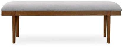 Large upholstered dining bench with gray fabric cushion and brown wood legs on Tampa Home & Garden Store