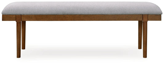 Large upholstered dining bench with gray fabric cushion and brown wood legs on Tampa Home & Garden Store