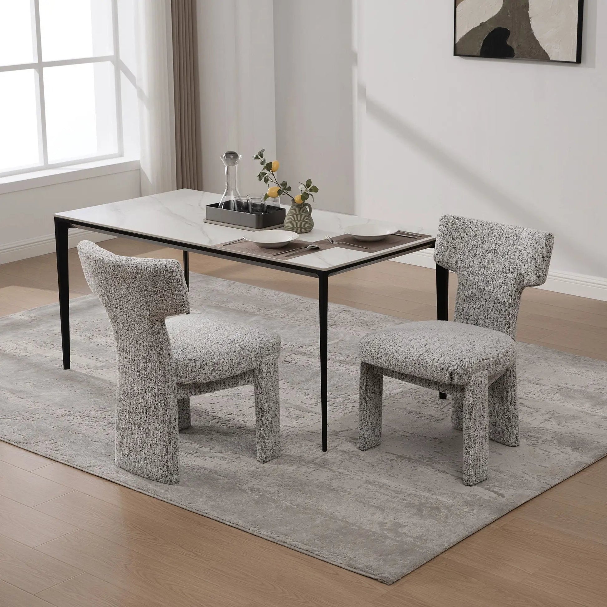 Armless curved-back accent chairs in light gray textured fabric with black legs on Tampa Home & Garden Store