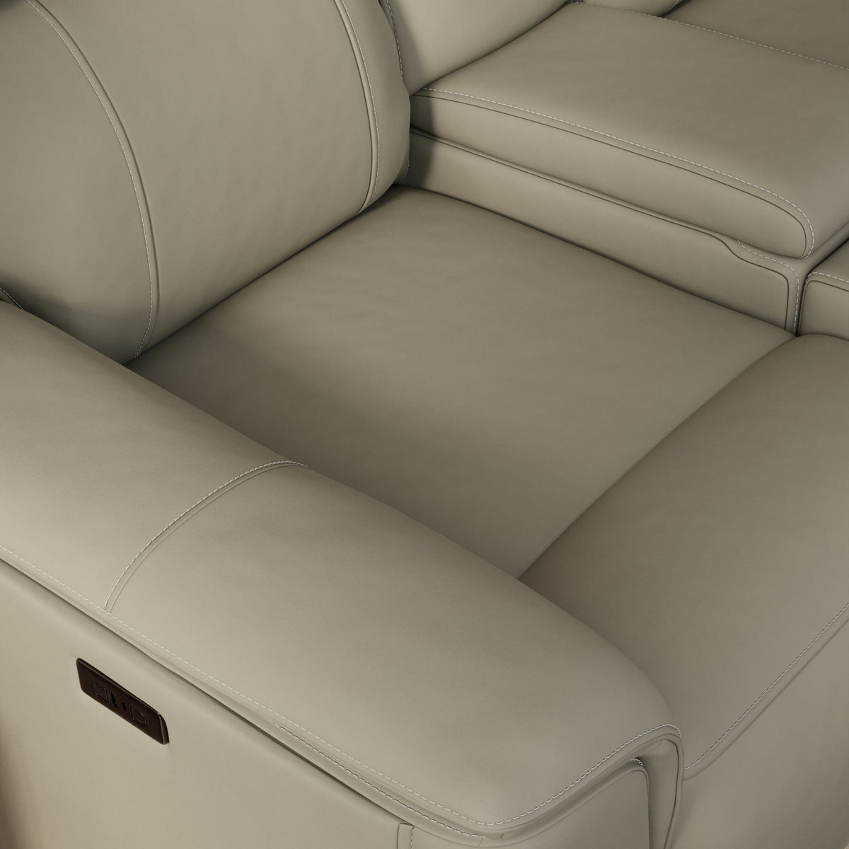 Dual Power Reclining Loveseat and Center Console in beige leather, visible stitching on Tampa Home & Garden Store
