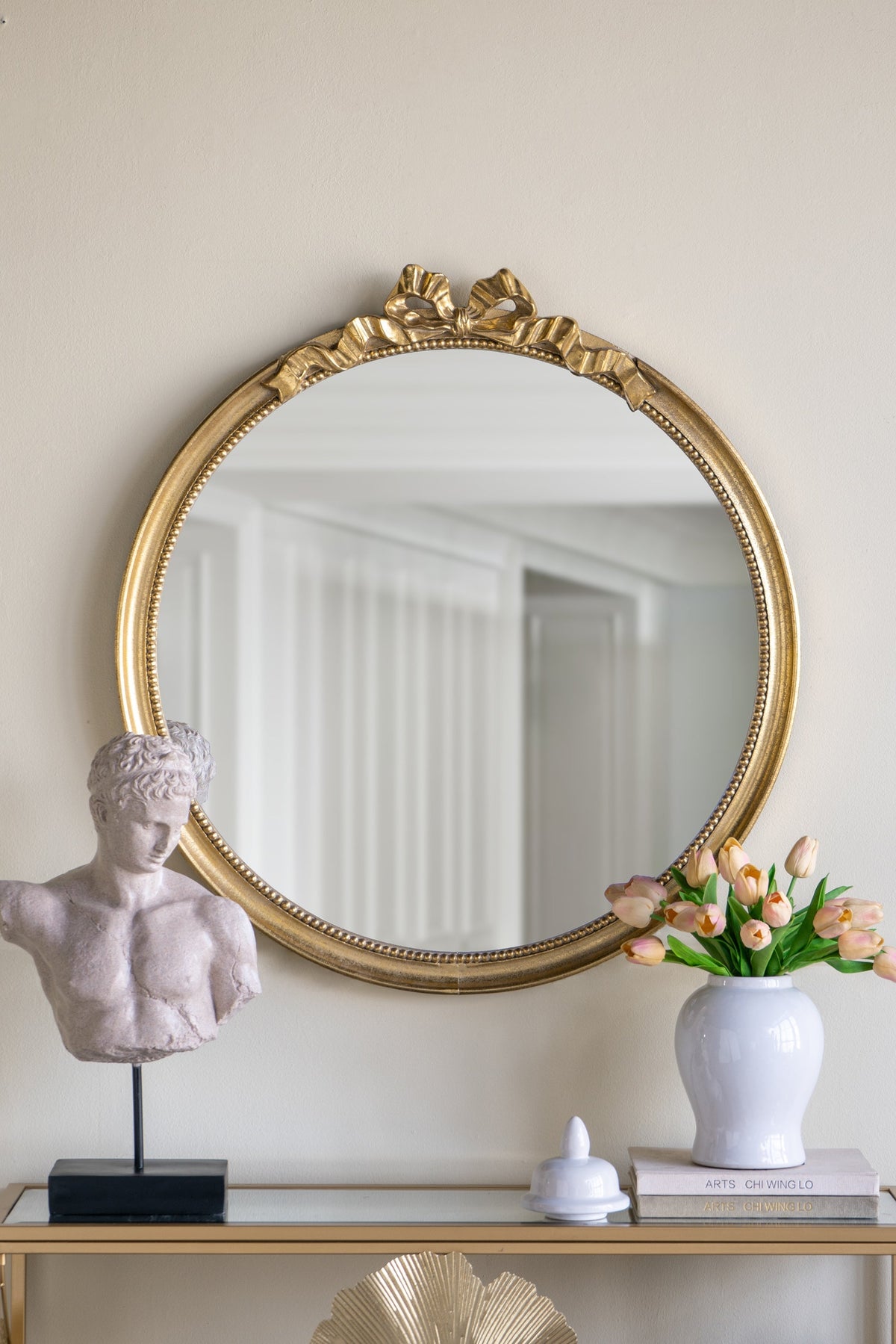 Round decorative gold wood frame wall mirror with a scrollwork crown on Tampa Home & Garden Store
