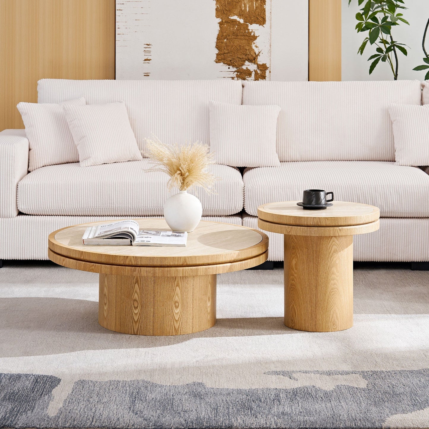 Two round wooden nesting coffee tables with light oak finish in front of a beige sofa on Tampa Home & Garden Store
