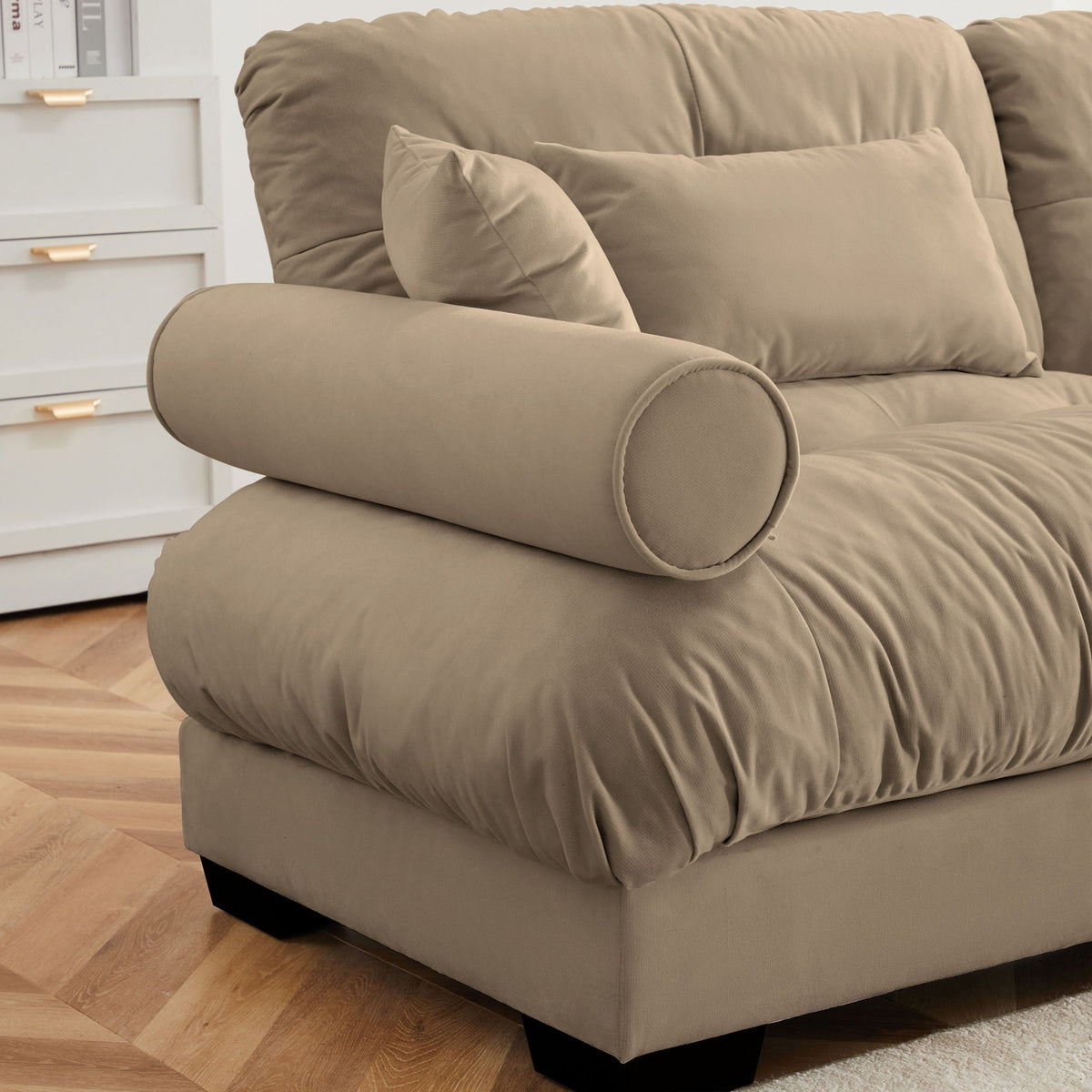 Beige fabric sectional with rounded bolster armrests and matching throw pillows on Tampa Home & Garden Store