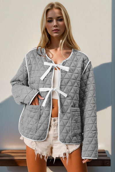 Quilted jacket by Stevvex in gray with white contrast trim, tie-front and pockets on Tampa Home & Garden Store