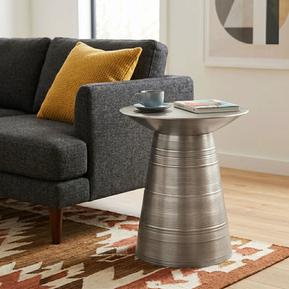 Sheridan handcrafted metal accent table with ribbed base beside a gray sofa on Tampa Home & Garden Store