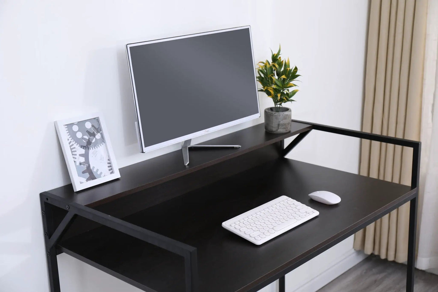 Console table with slim black metal frame and dark wood top, monitor, keyboard, plant on Tampa Home & Garden Store