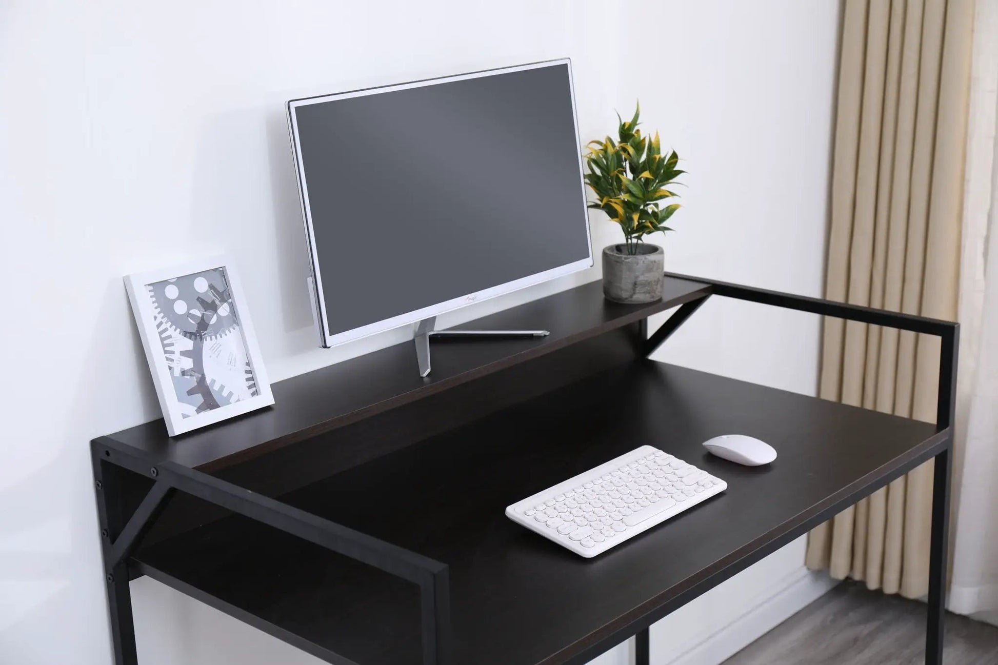 Console table with slim black metal frame and dark wood top, monitor, keyboard, plant on Tampa Home & Garden Store