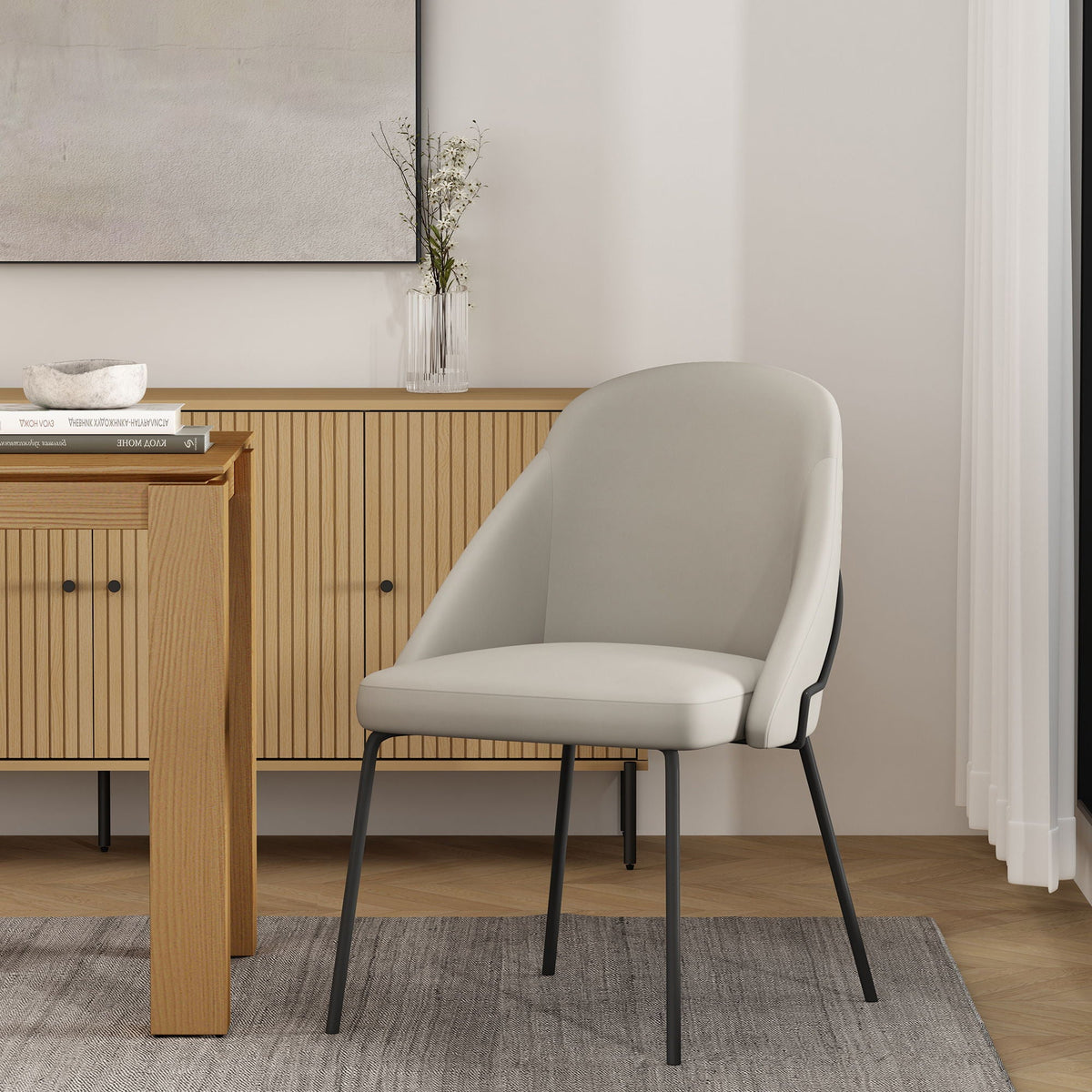 Modern vegan upholstered dining chair with light gray upholstery and black metal legs on Tampa Home & Garden Store