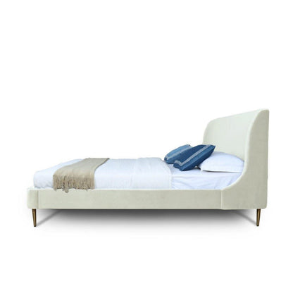 Heather upholstered bed with curved ivory headboard by HouseOfZazla white bedding blue pillows on Tampa Home & Garden Store